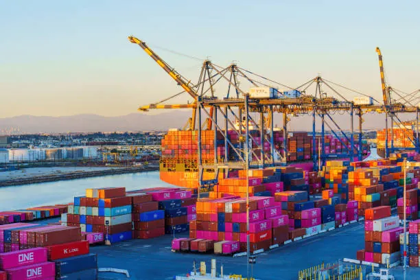 Container port terminal with cranes at dusk