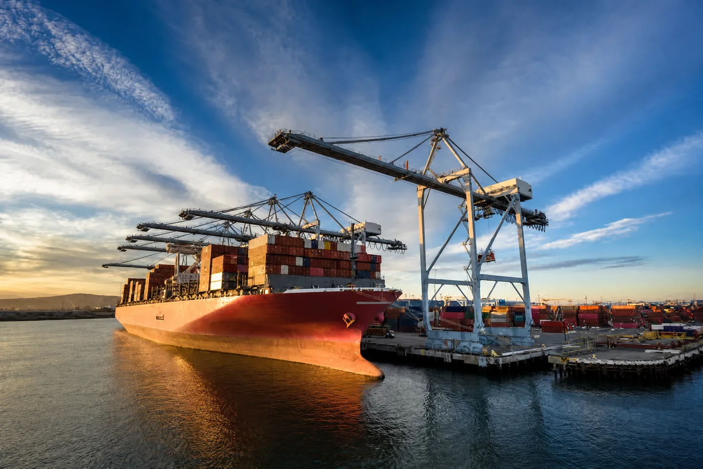 Container port with truck at sunset